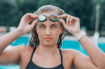 Close-up portrait of a teenage girl in swimming pool