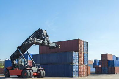 View of machinery on pier against blue sky