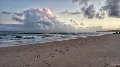 Scenic view of beach against sky during sunset