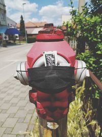 Rear view of man standing on footpath in city