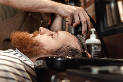 Midsection of barber grooming customer