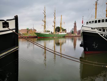 Boats moored on river against sky