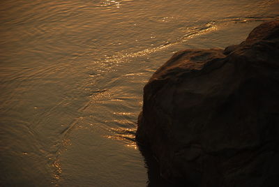 High angle view of rock formation at sea during sunset