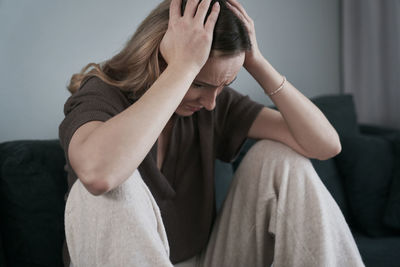 Depressed woman sitting at home