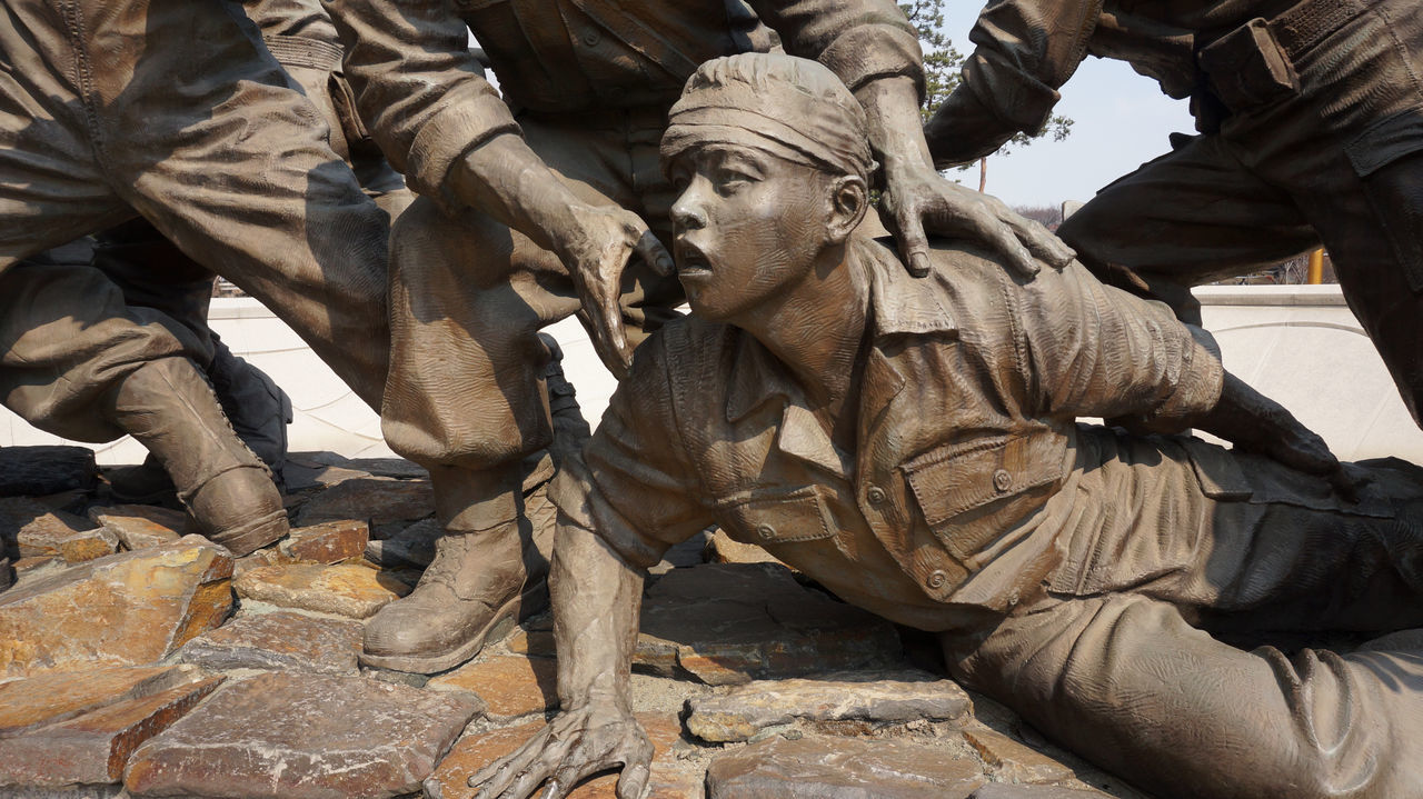 close-up, outdoors, statue, no people, sword, day