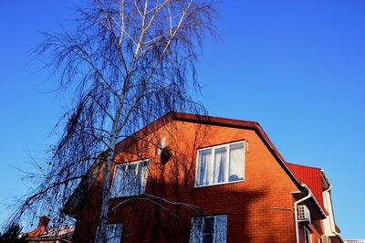 Low angle view of building against clear blue sky