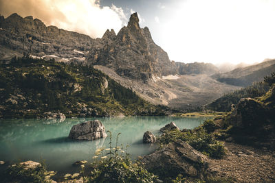 Scenic view of lake and mountains against sky