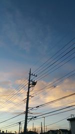 Low angle view of birds perching on power line