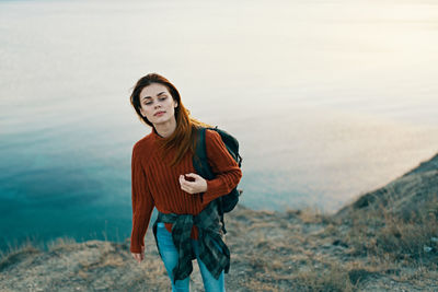 Portrait of young woman standing in water