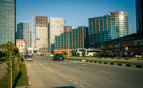 View of city street and buildings against sky