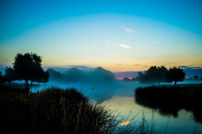 Scenic view of lake against cloudy sky