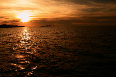 Scenic view of sea against orange sky