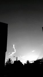 Low angle view of silhouette built structure against sky