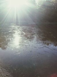 Scenic view of bright sun over water