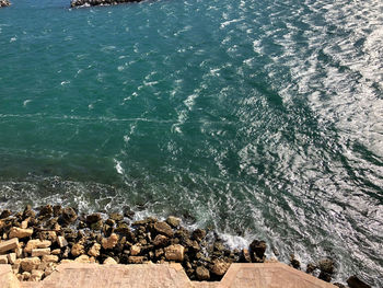 High angle view of rocks in sea