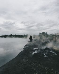 Rear view of man standing on beach
