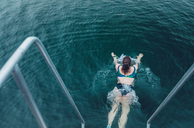 High angle view of man swimming in sea