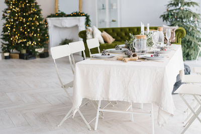 Christmas holiday beautifully set table in a spacious bright dining room or living room in the house