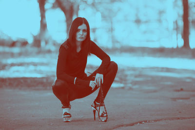 Portrait of young woman standing on land