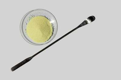 High angle view of bread in plate against white background