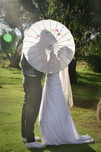 Rear view of couple with umbrella