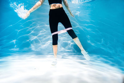 Low section of woman in swimming pool