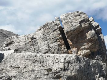 Low angle view of rock formation against sky