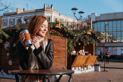 Young woman wearing mask at table