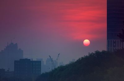 Cityscape against sky during sunset