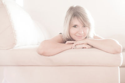 Portrait of woman relaxing on sofa at home