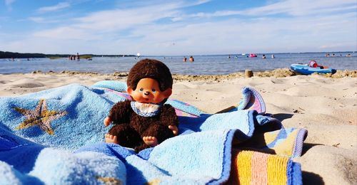 Full length of boy on beach against sky