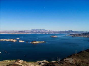 Scenic view of calm sea against clear blue sky