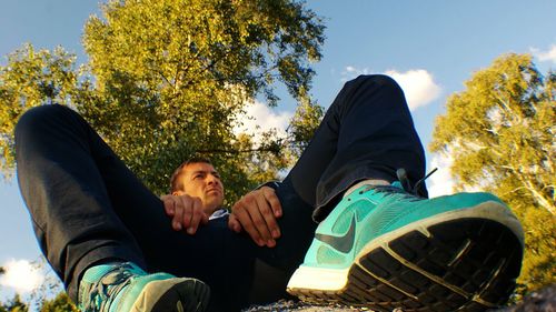 Rear view of friends sitting on grassy field