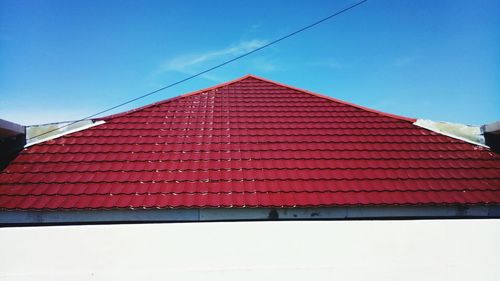 Low angle view of house roof against sky