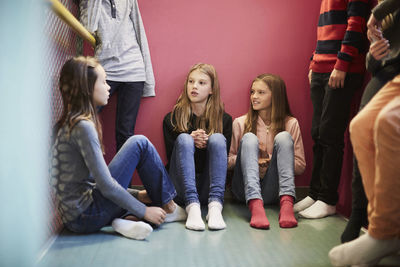Girls and boys having discussion in middle school