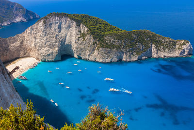 High angle view of boats in sea against mountain