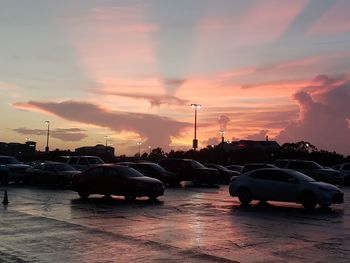 Cars on road in city during sunset