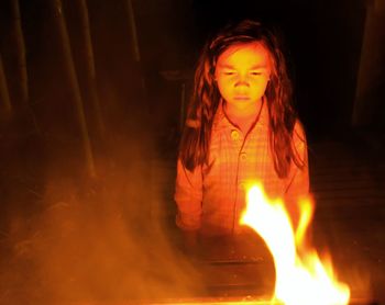 Mid adult woman with light painting at night