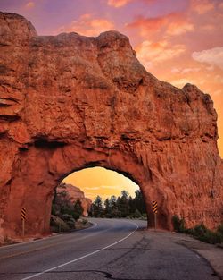 Road amidst rock formation against sky