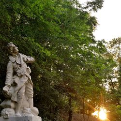 Low angle view of statue against trees