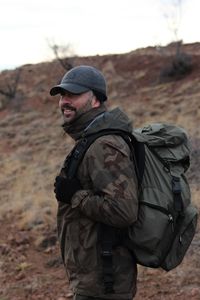 Hiking man standing on field