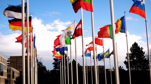 Low angle view of flags against sky