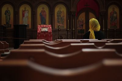 Rear view of woman sitting at church