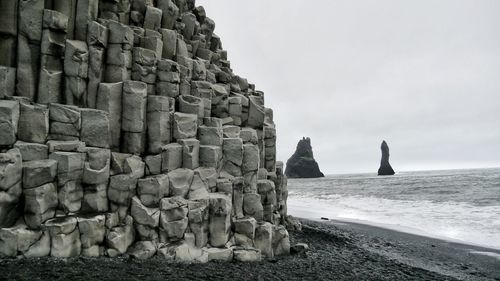 Natural basalt rock formation at black sand beach of reynisfjara