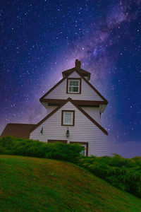 Digital composite image of building against sky at night