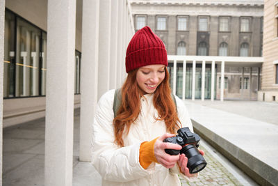 Young woman using mobile phone in city