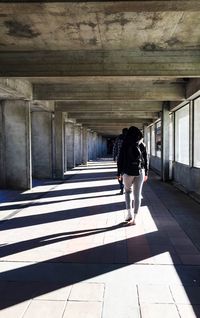 Full length of woman walking under bridge