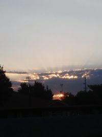 Scenic view of electricity pylon at sunset