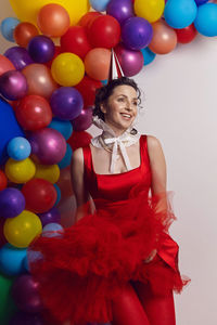 Portrait of young woman with balloons