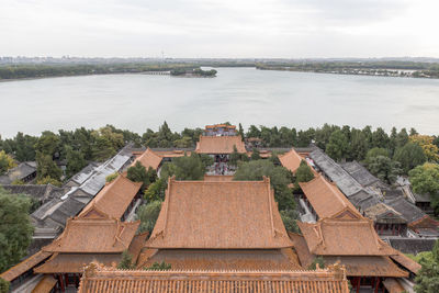 High angle view of river amidst buildings against sky